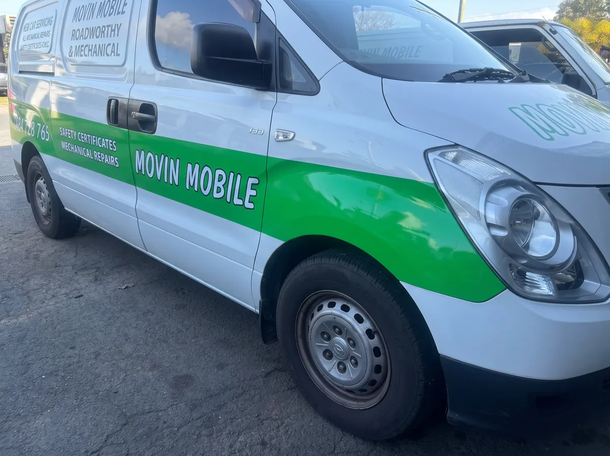 Green Movin Mobile stripe on the side of a Hyundai service van