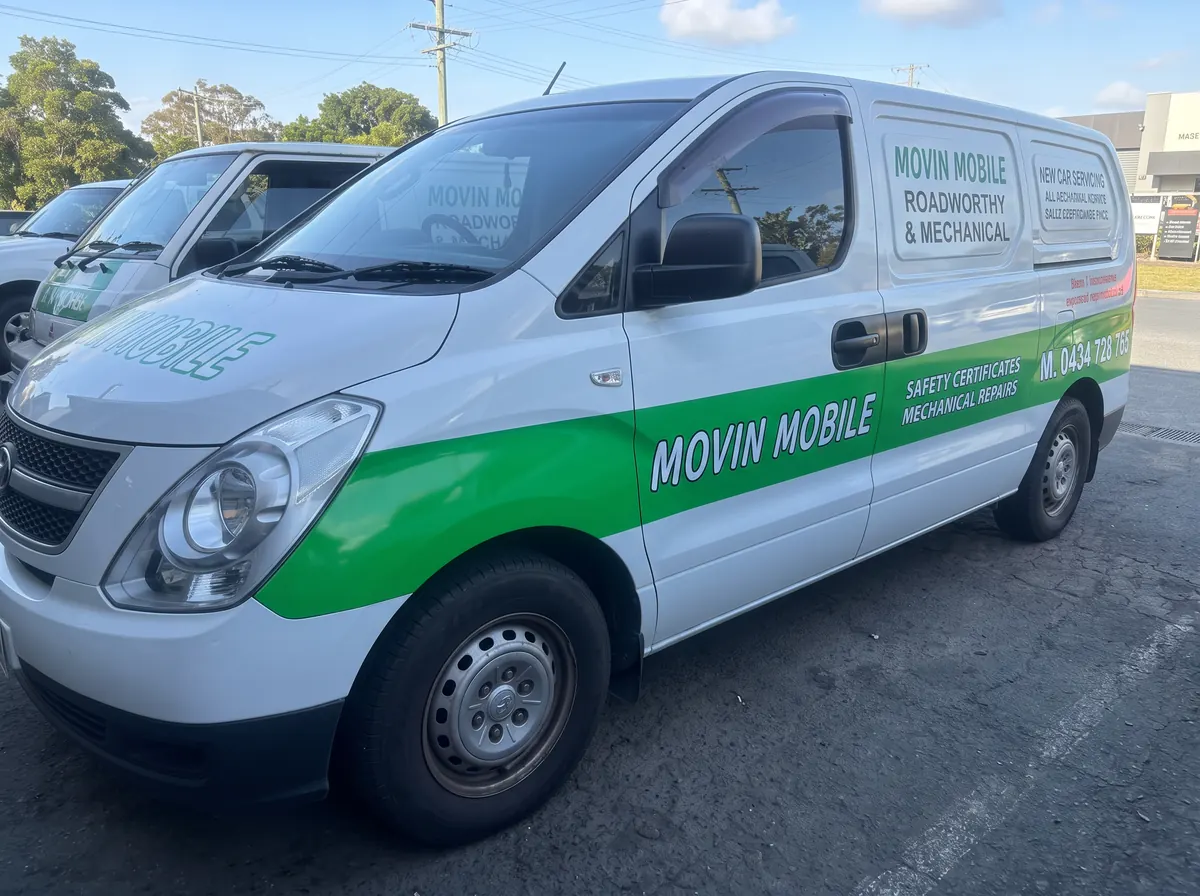 White and green Movin Mobile service van viewed from the side