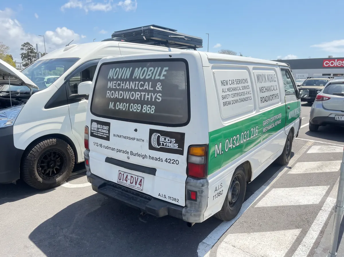 White and green Movin Mobile service van parked at a callout